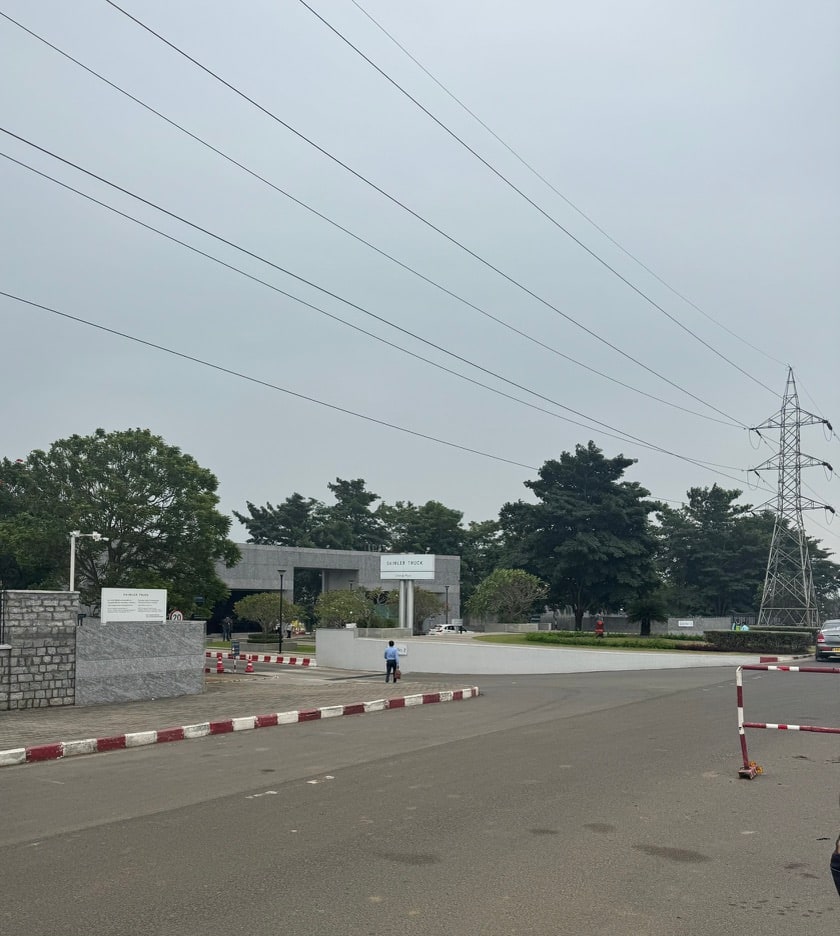 The entrance to an industrial campus beneath high-voltage power lines