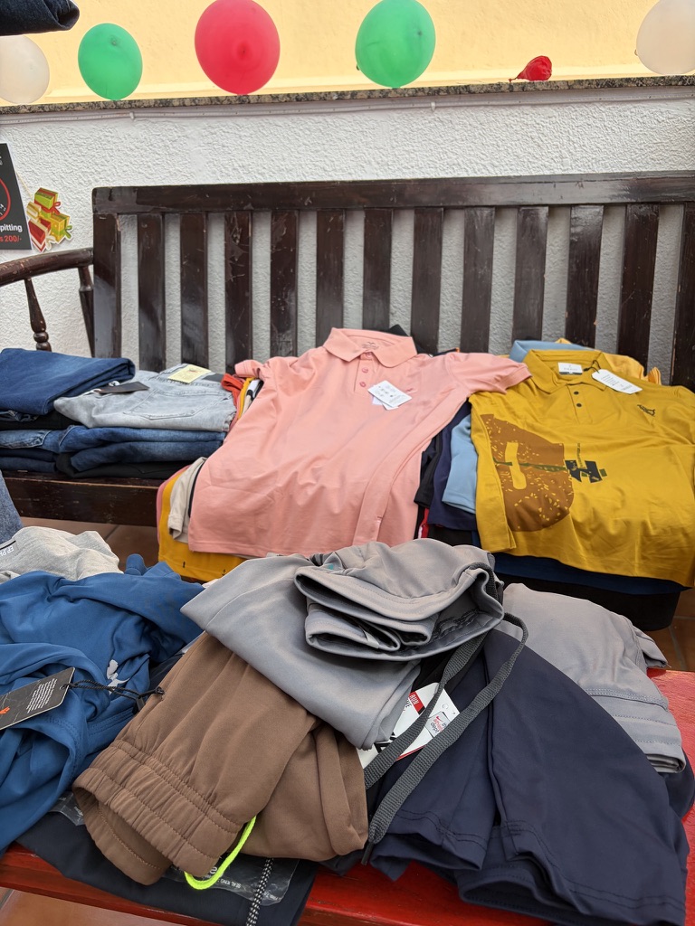 Clothing arranged for members at a Nia marketplace event